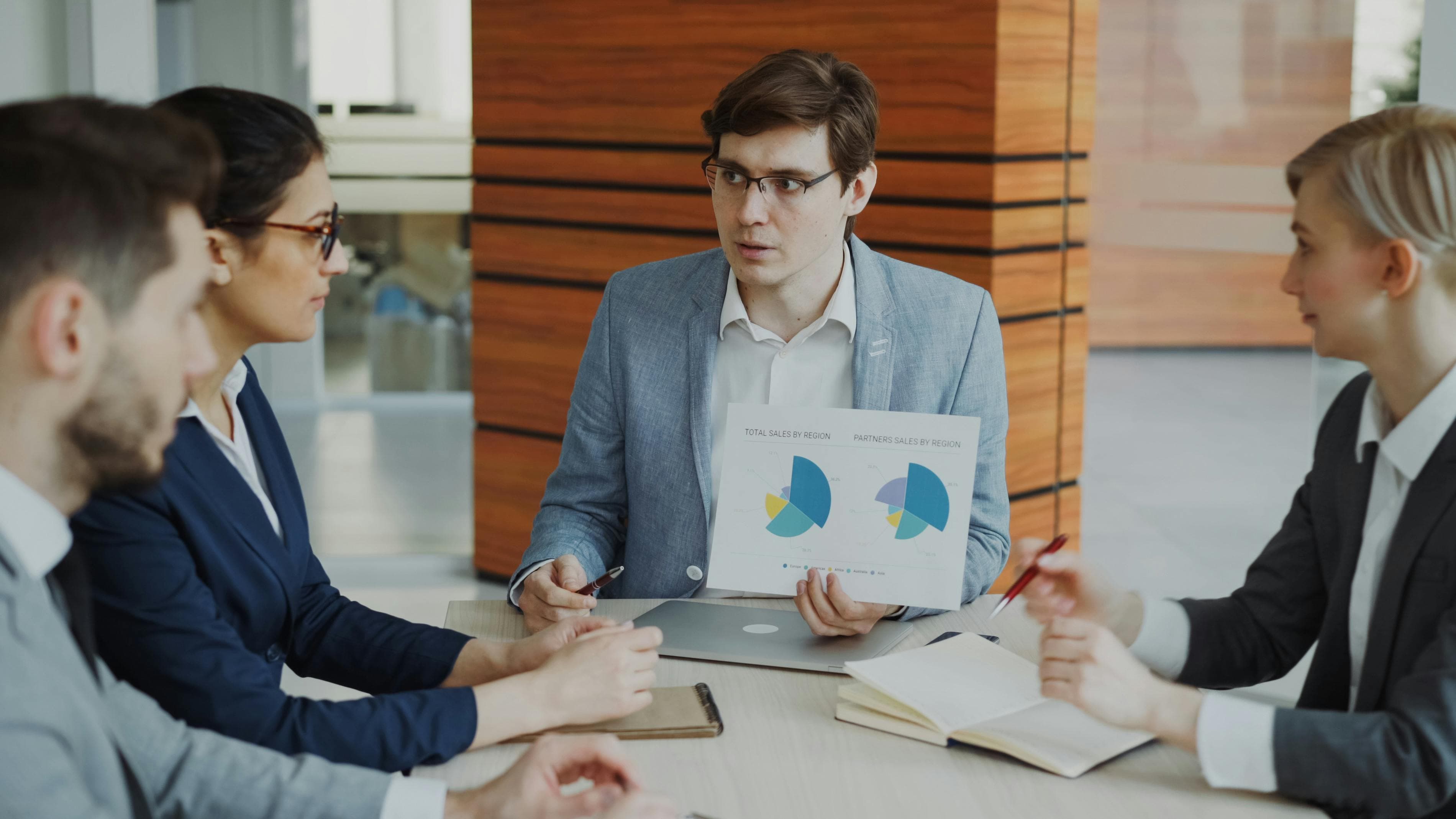 Team discussing charts during a business meeting