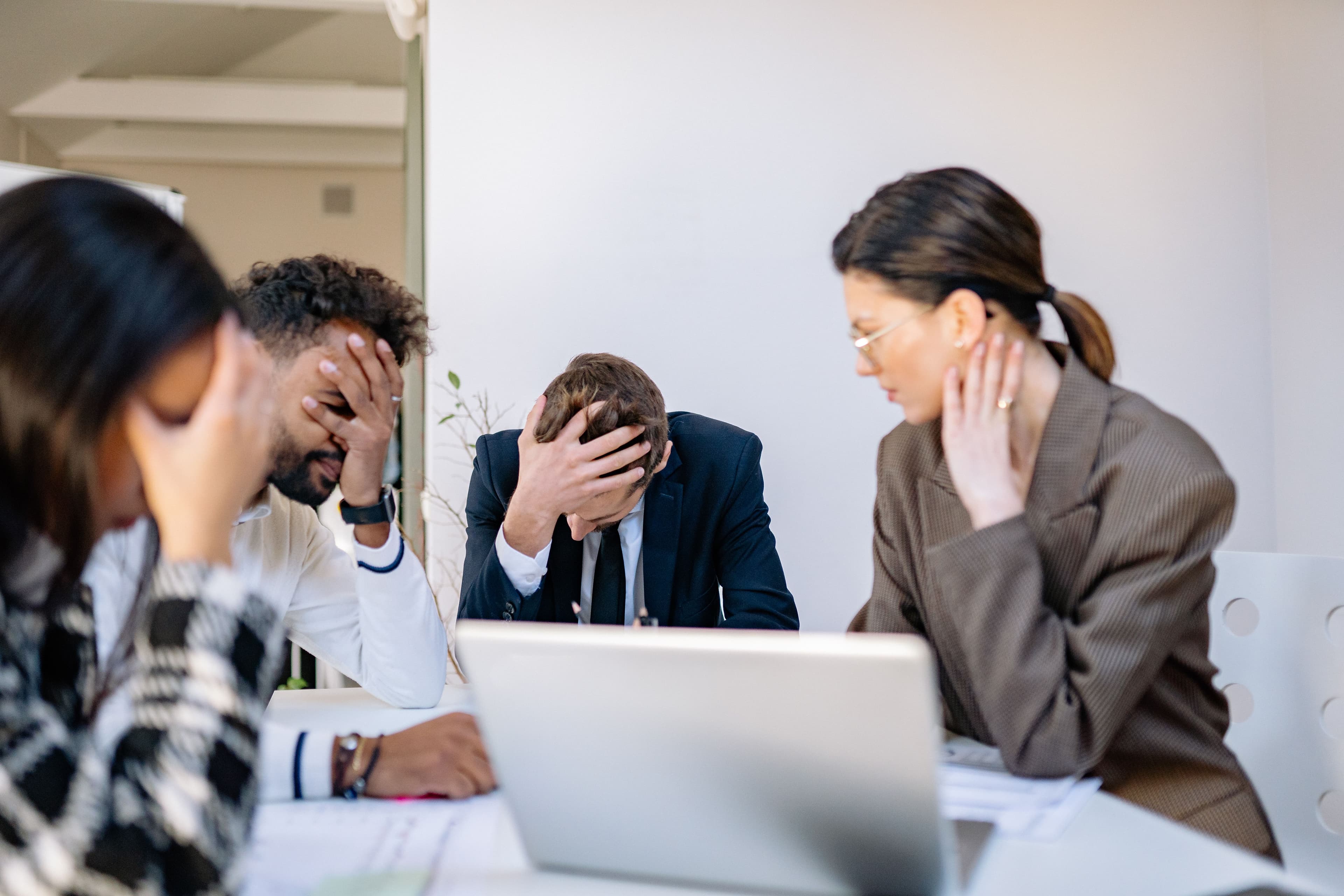 A group of stressed business professionals in an office setting