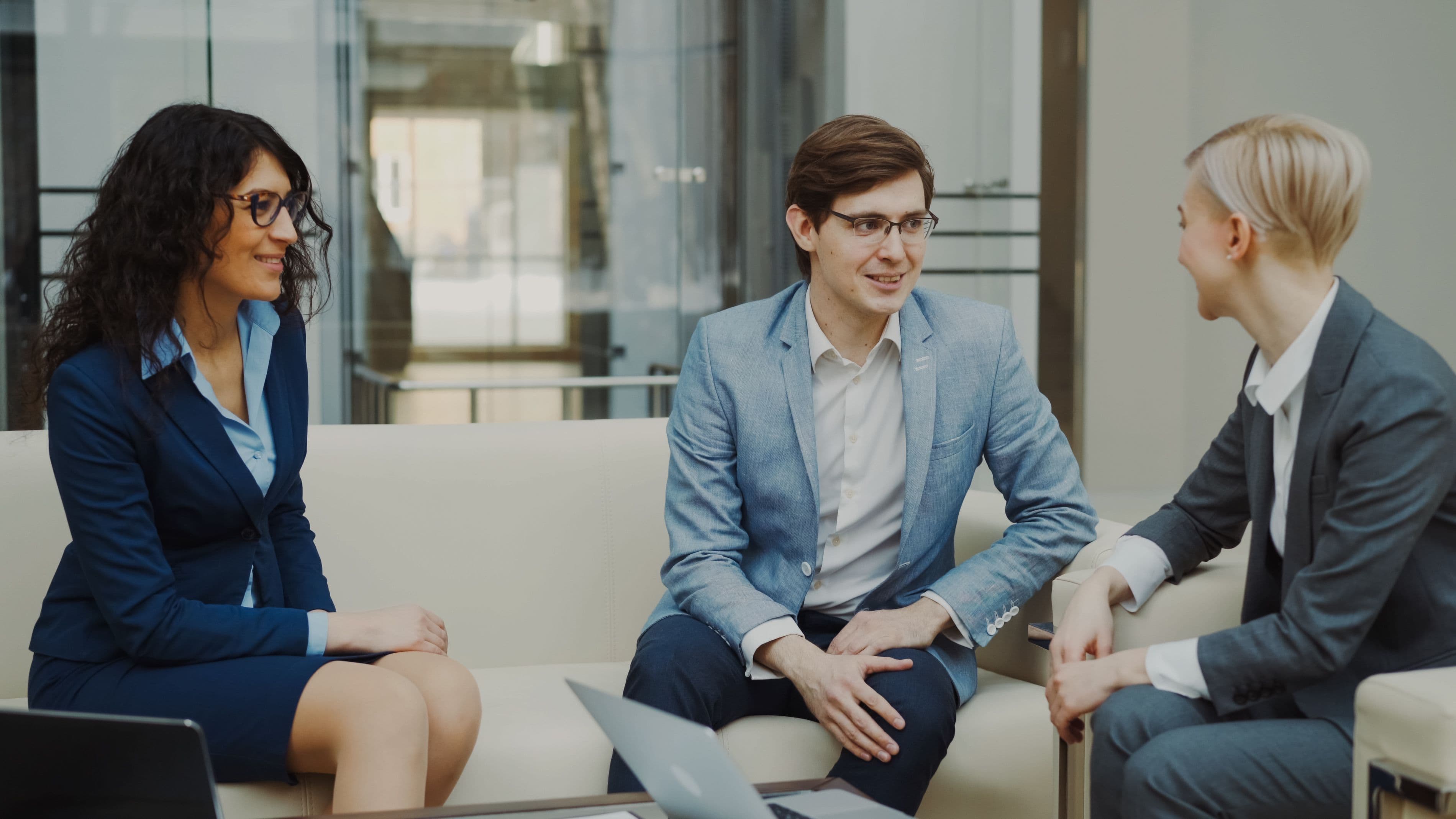 Three business professionals engaged in a discussion