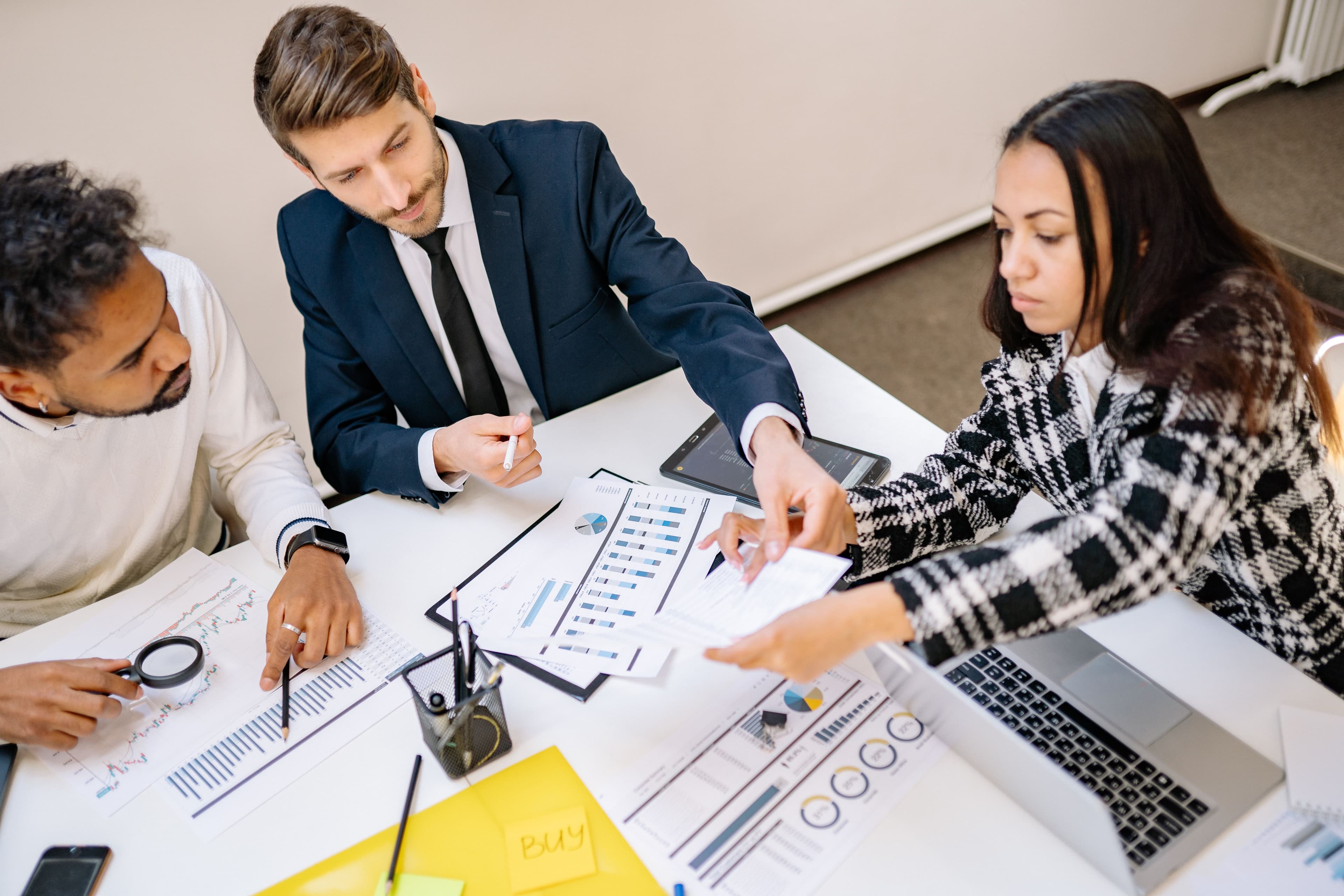 Business professionals engaging in a collaborative meeting with charts and documents
