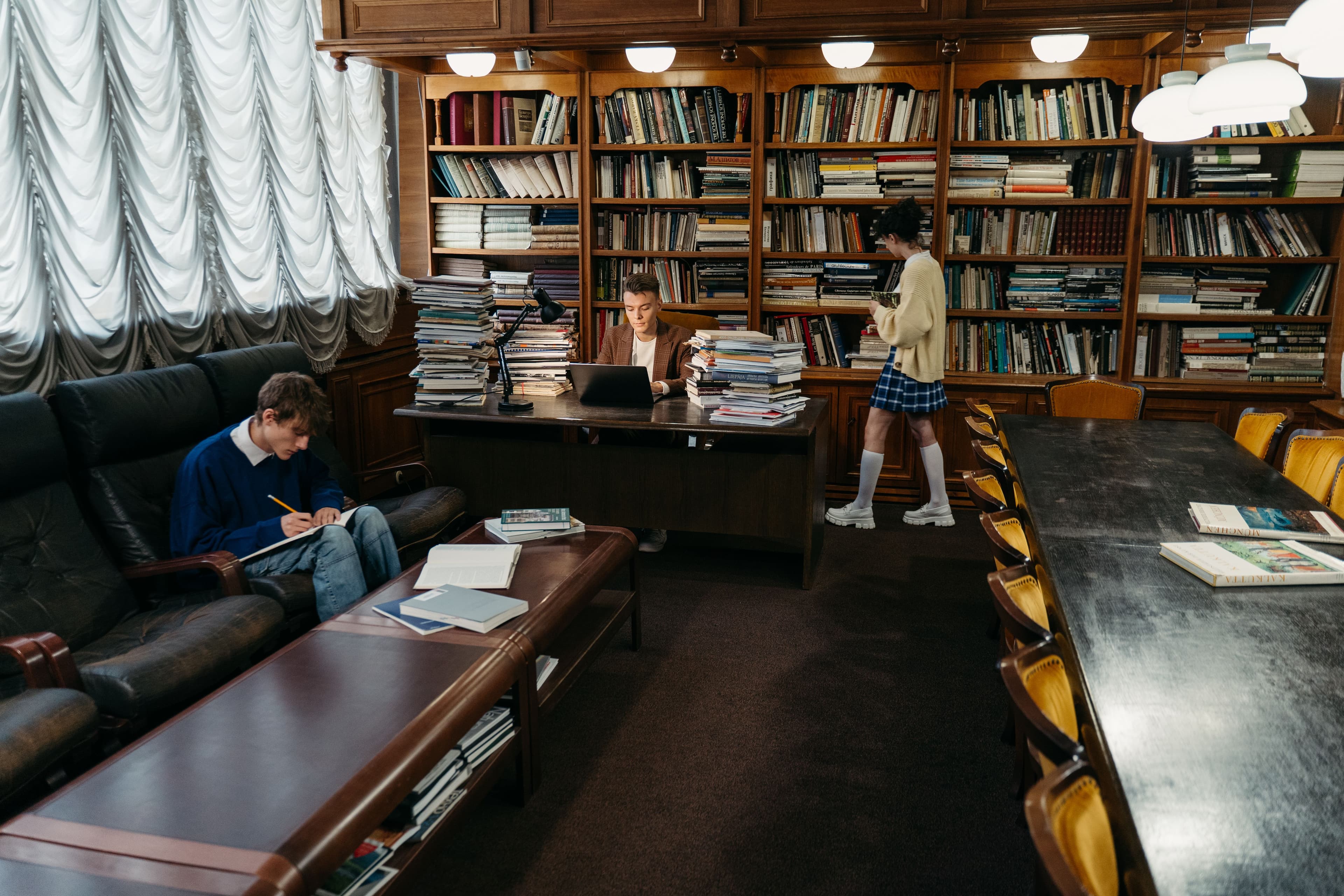 Students engaging in study and research within a classic library setting