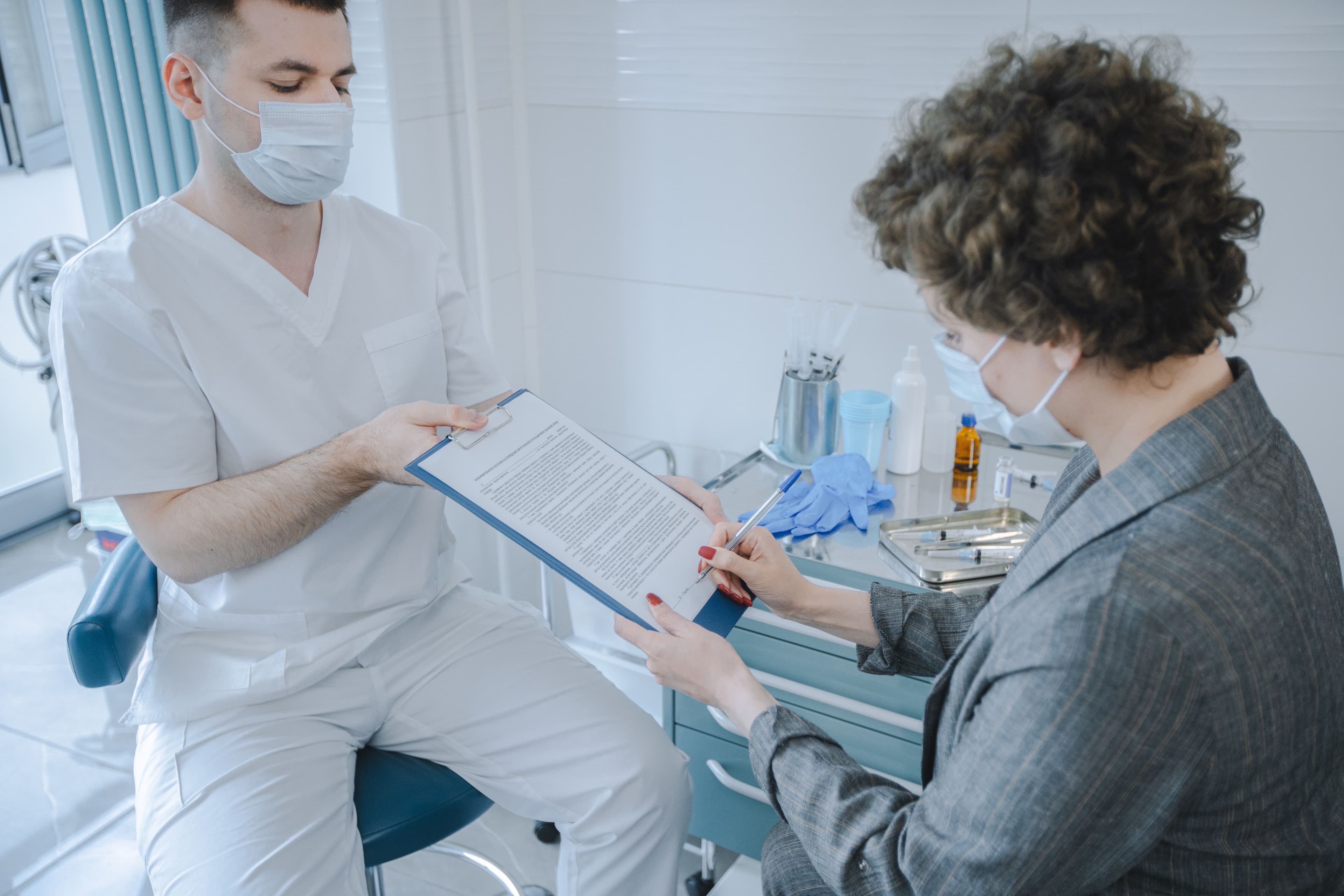 A medical professional and patient reviewing documents in a clinic setting