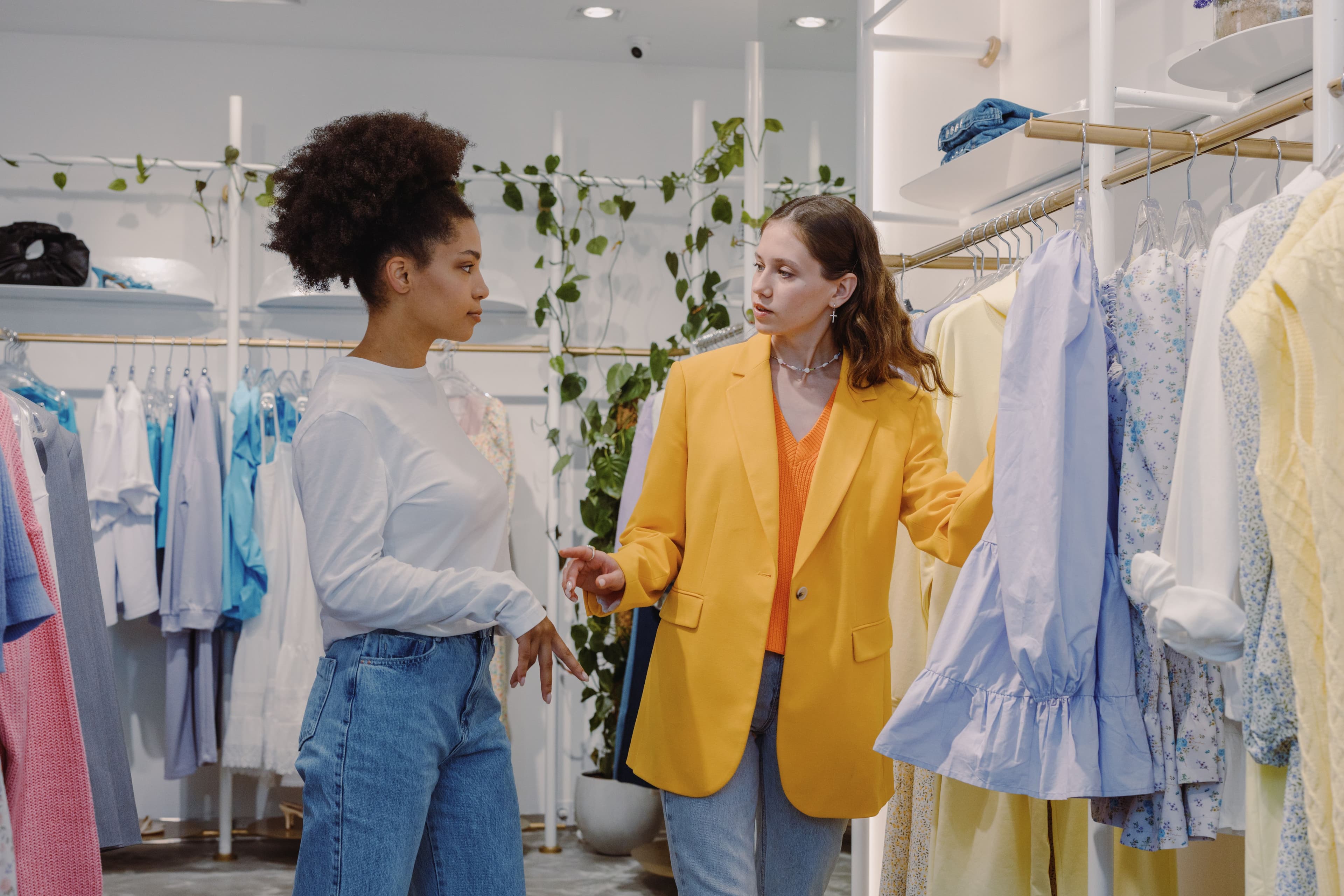 Two women in a boutique store browsing clothes
