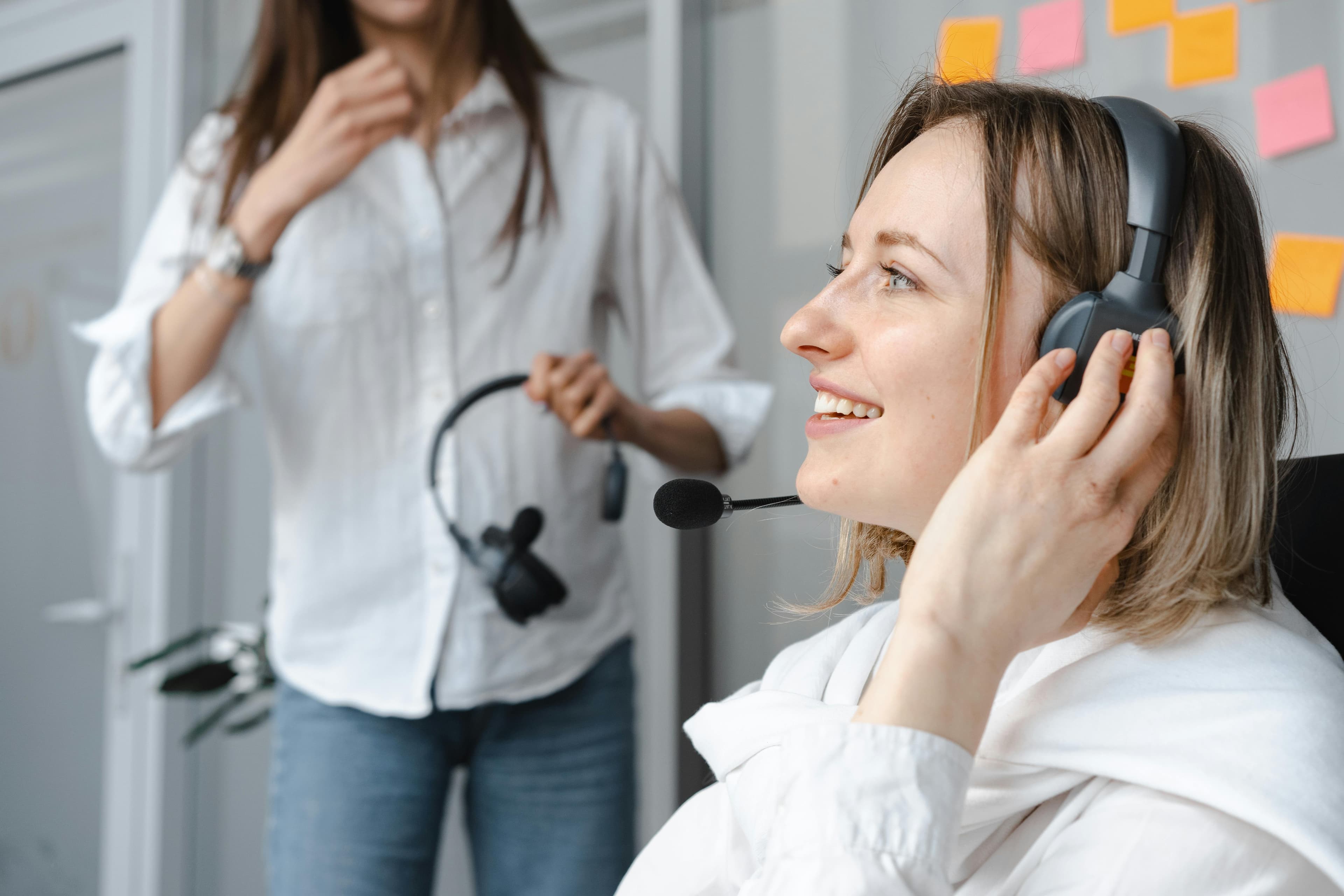Close-up photo of smiling woman wearing headphones