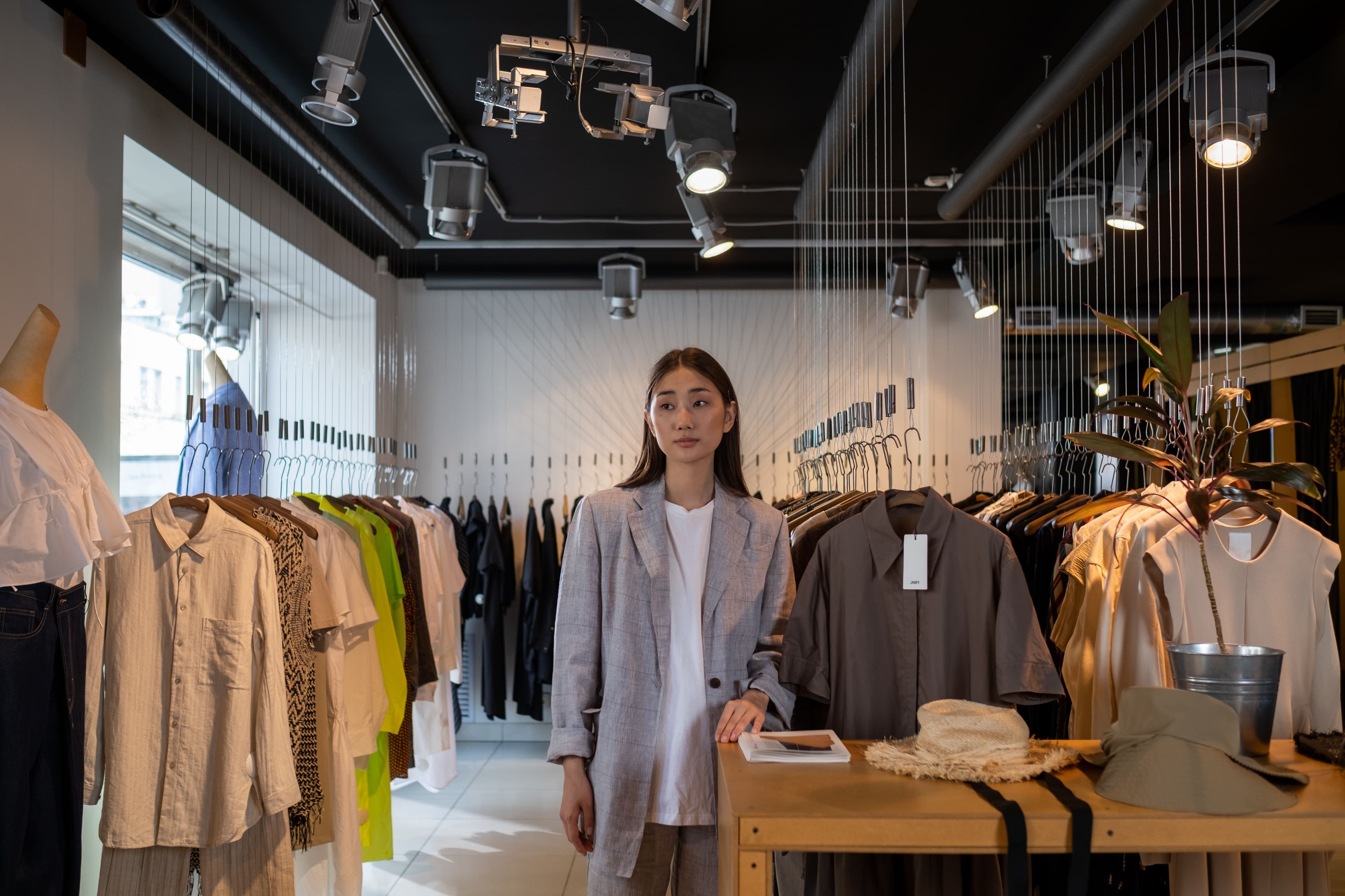 Stylish Asian woman standing in a modern clothing boutique