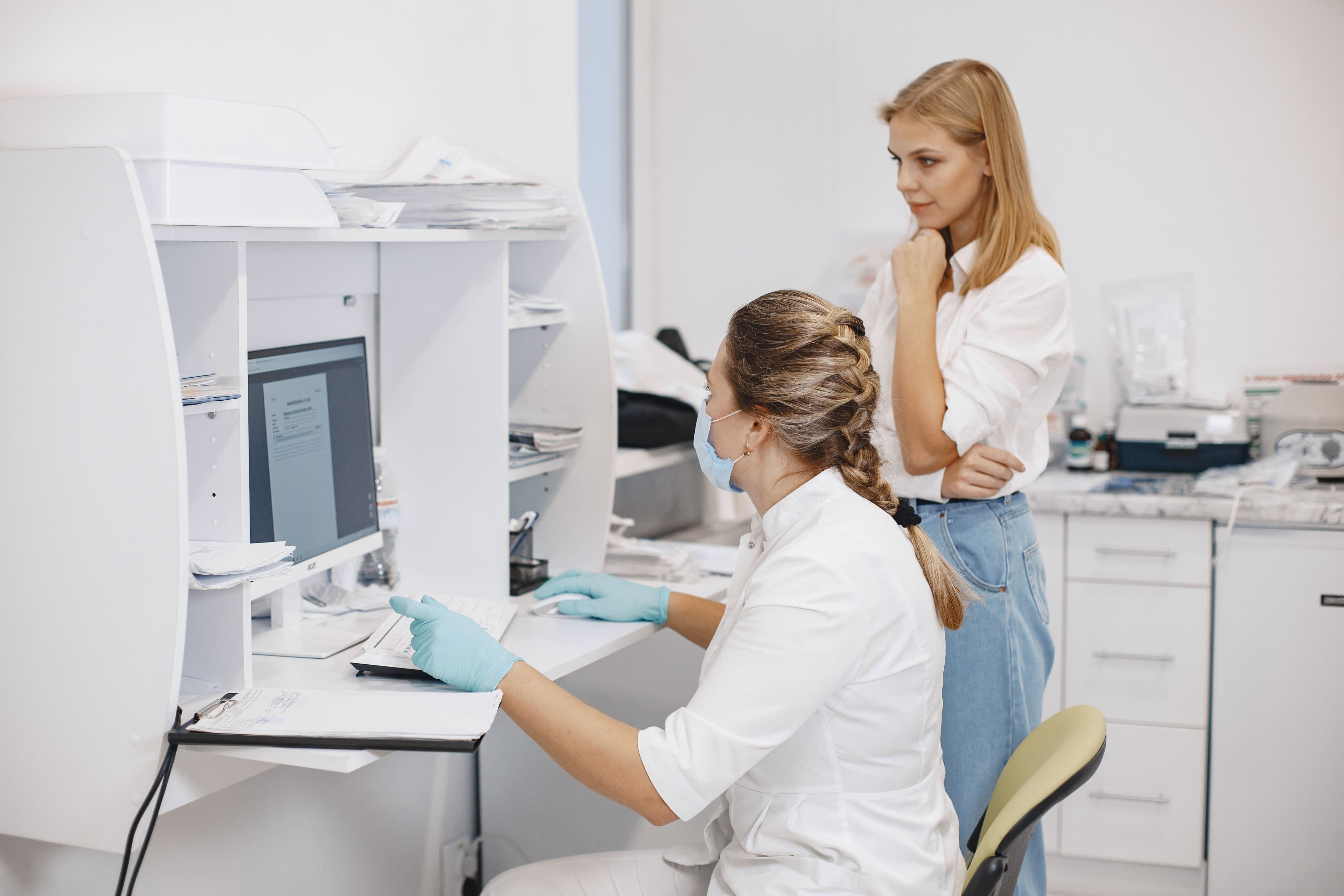 Two female healthcare workers in a clinical office
