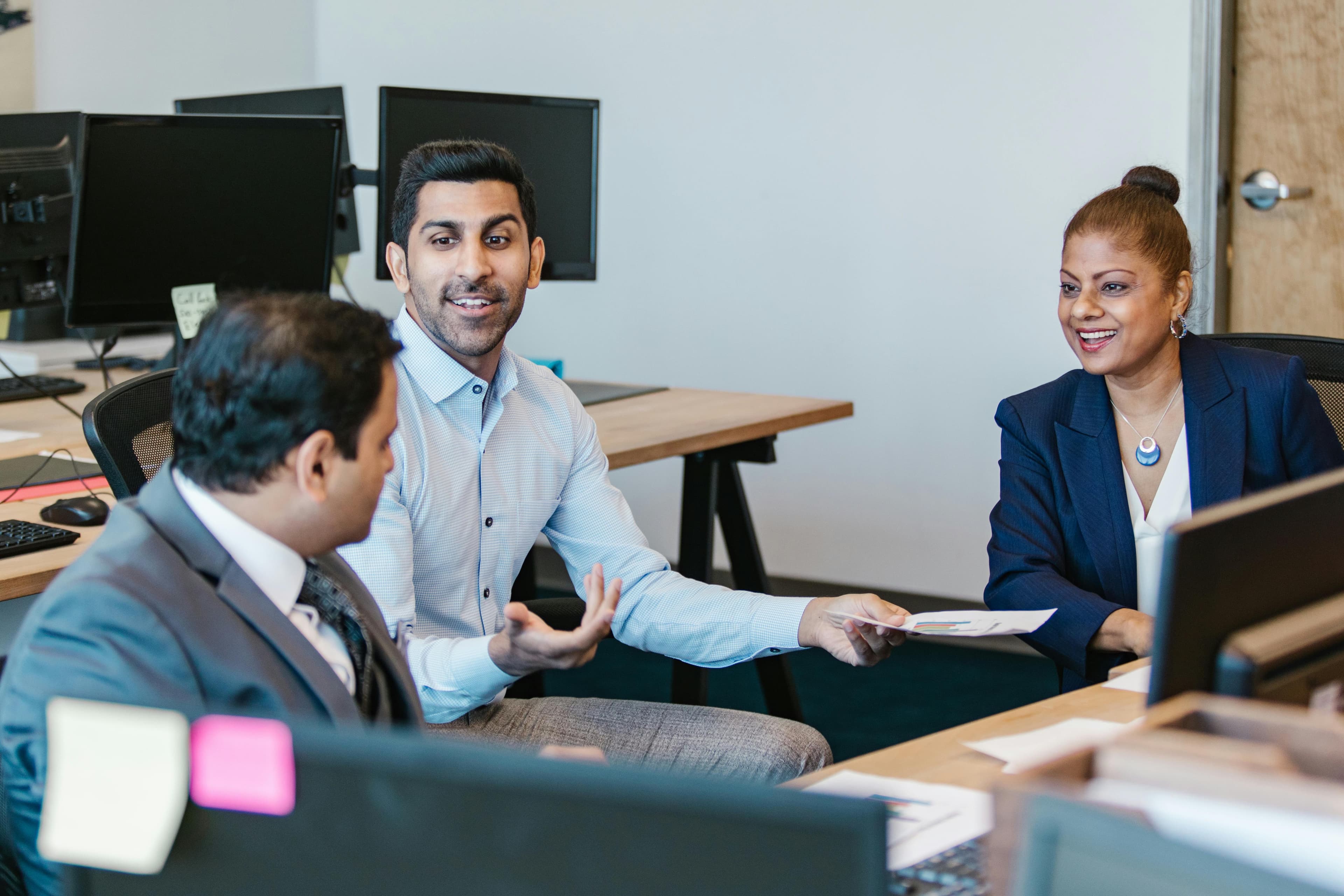 Colleagues engaging in a productive discussion in a modern office setting