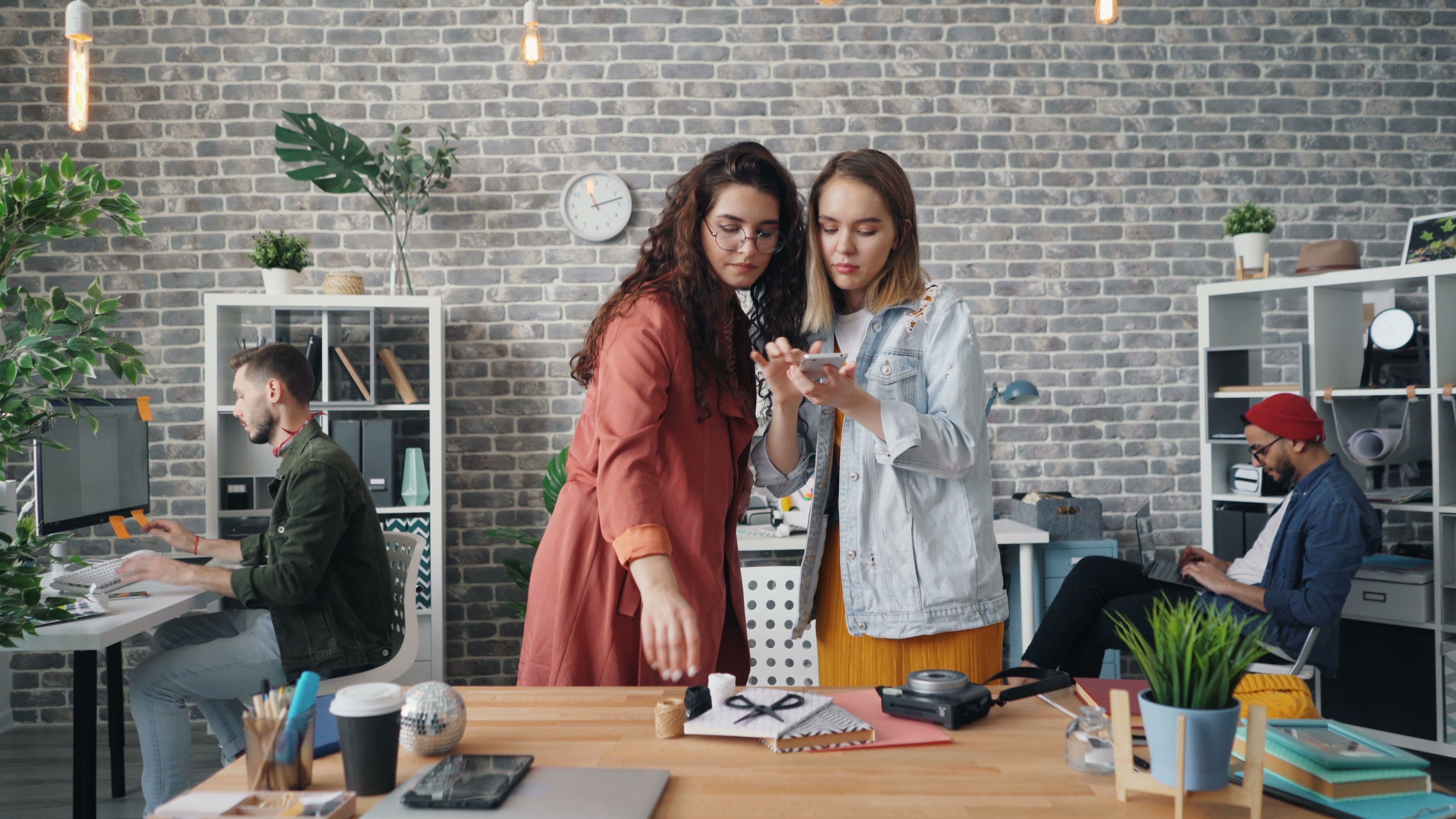 Collaborative team of men and women in a modern office workspace