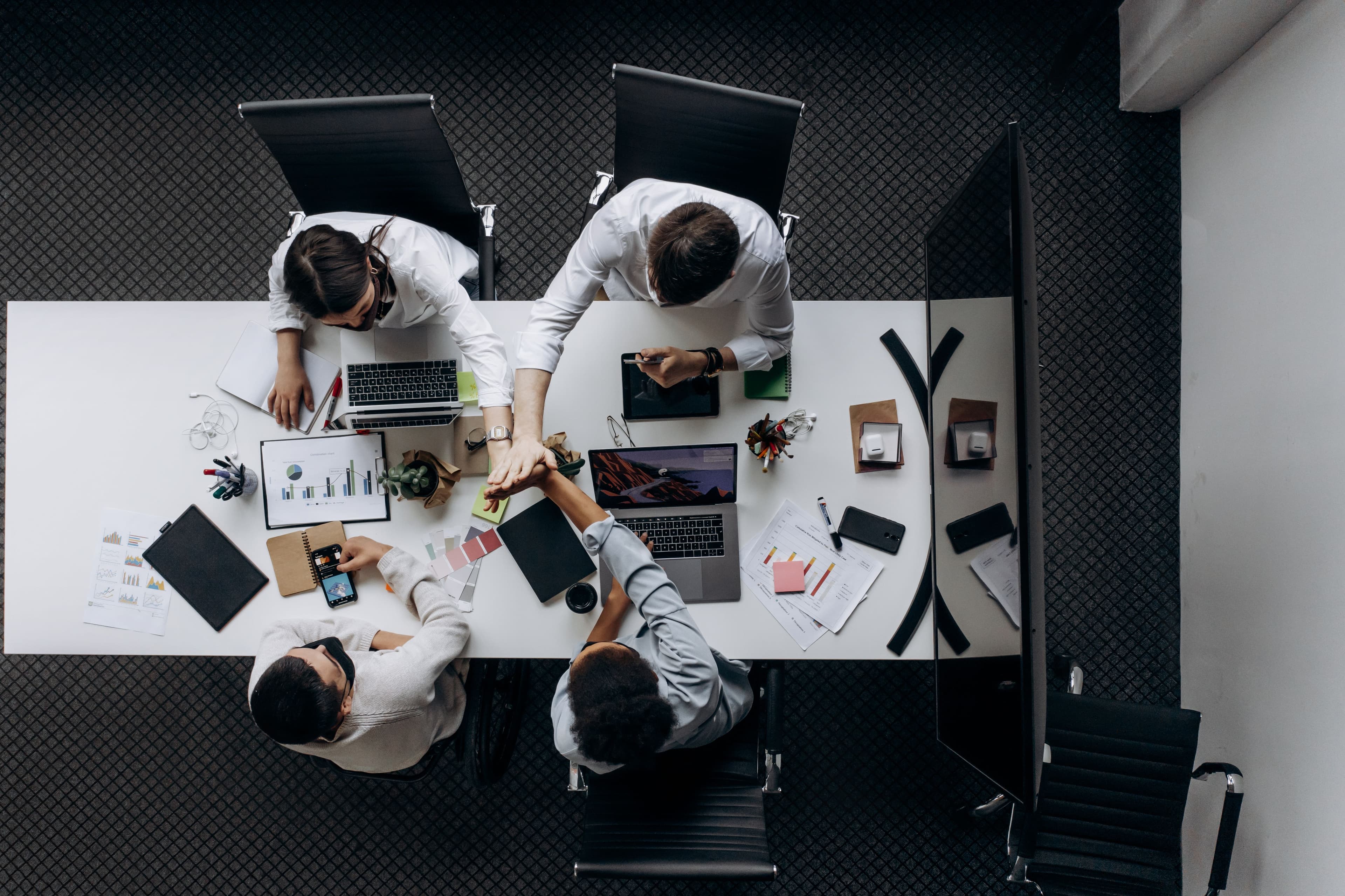 High angle view of colleagues collaborating around a conference table